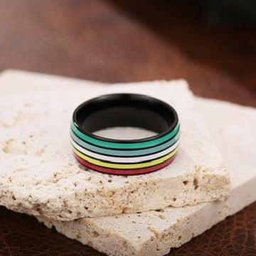 Disability Pride ring with black stainless steel band and colorful stripe detail — Outer Peace Gear