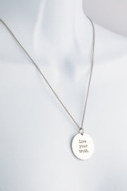 Live Your Truth engraved circular stainless steel pendant in polished or brushed finish on a chain — Outer Peace Gear